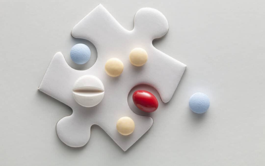 A puzzle piece with pills on top to illustrate compounded medications.